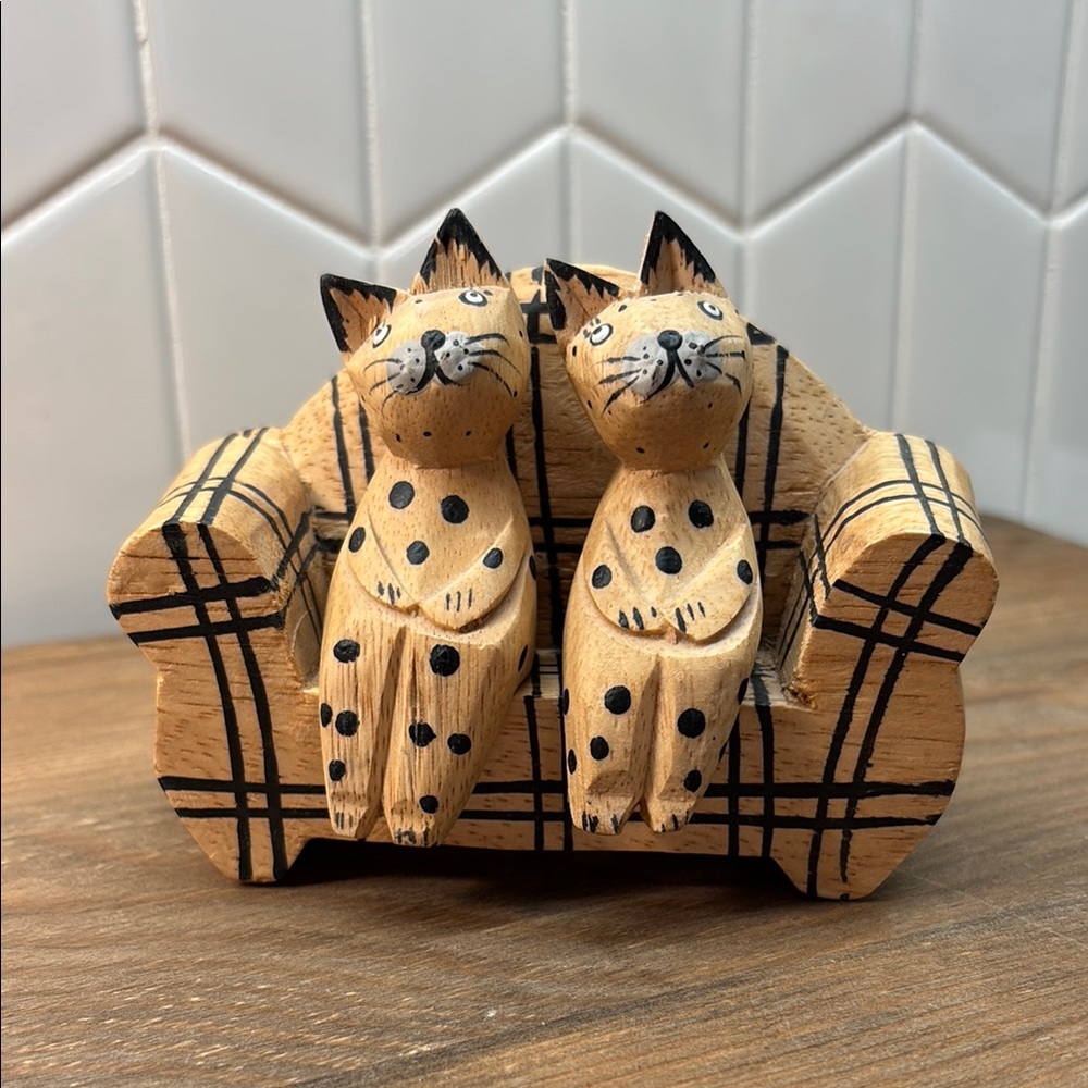 Hand carved wooden cats on couch